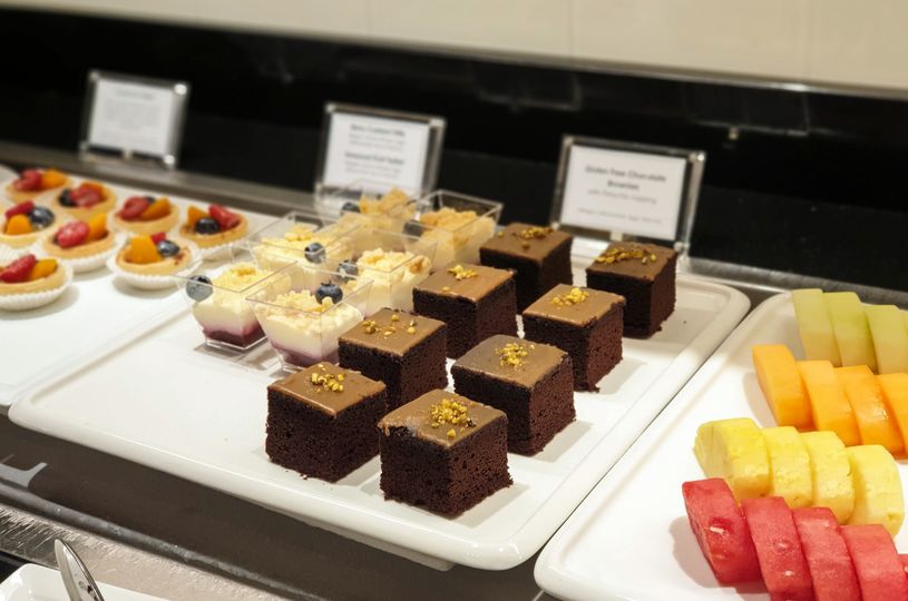 From L to R: Fruit tarts, berry trifles, chocolate brownies, sliced fruits